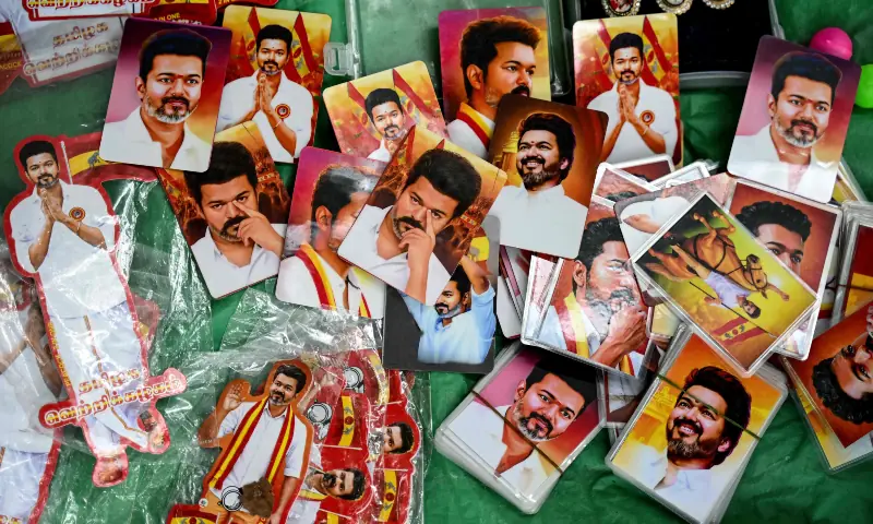A vendor sells pictures of Indian actor and Tamilaga Vettri Kazhagam (TVK) party president C. Joseph Vijay during vote counting for the Tamil Nadu Legislative Assembly elections, at the party headquarters in Chennai on May 4, 2026. &mdash; AFP