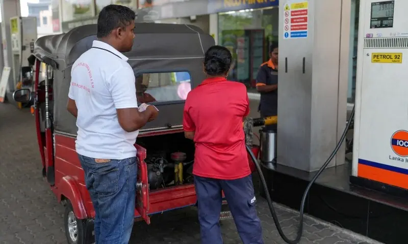 Kelum Dissanayaka, 37, an auto rickshaw driver, looks on as a petrol pump attendant fills his three-wheeler with petrol at a fuel station in Colombo, Sri Lanka on April 10, 2026. &mdash; Reuters