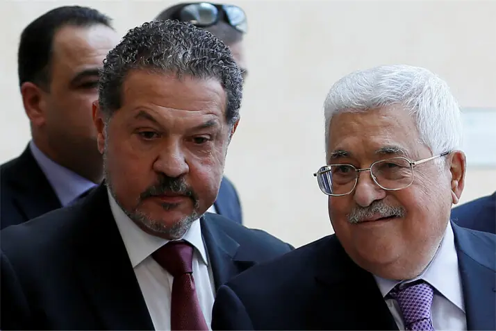 Palestinian President Mahmoud Abbas and his son Yasser leave a hospital in Ramallah.&mdash;Reuters/file