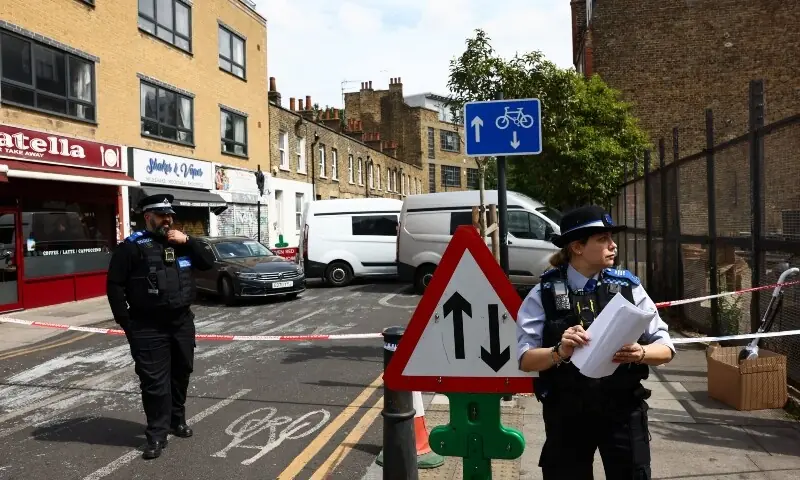 Police Community Support Officer (PCSO) and a Metropolitan Police Officer work at the scene of a suspected arson attack on a former synagogue in London, Britain on May 5, 2026. &mdash; Reuters