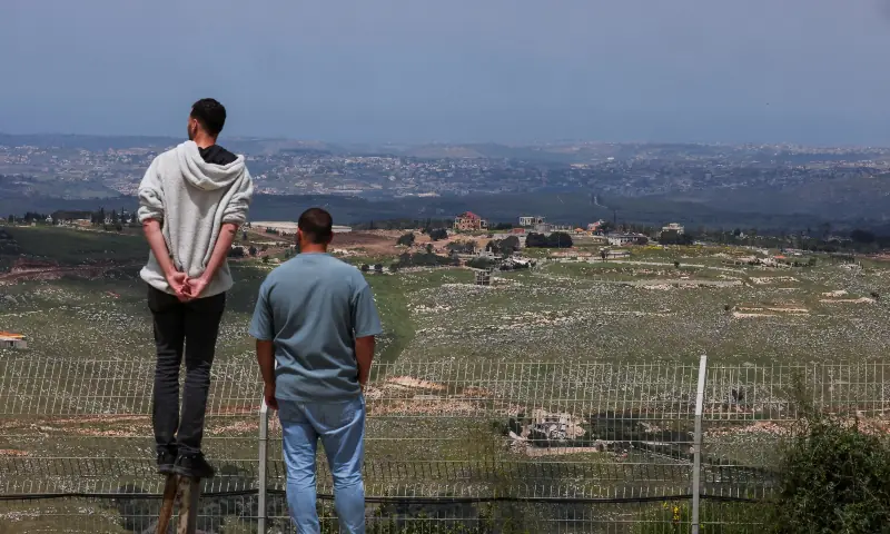 People look at destroyed buildings in southern Lebanon, as seen from the Israeli side of the Israel-Lebanon border, in northern Israel on May 6, 2026. &mdash; Reuters
