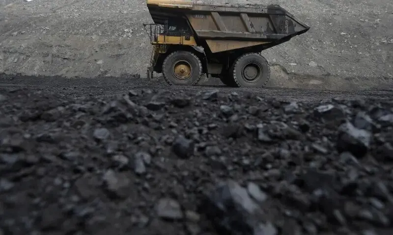 Image shows dump trucks haul coal and sediment at a coal mine. &mdash; Reuters/File