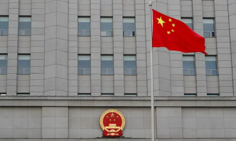 A Chinese national flag waves outside Beijing People's Court. &mdash; Reuters