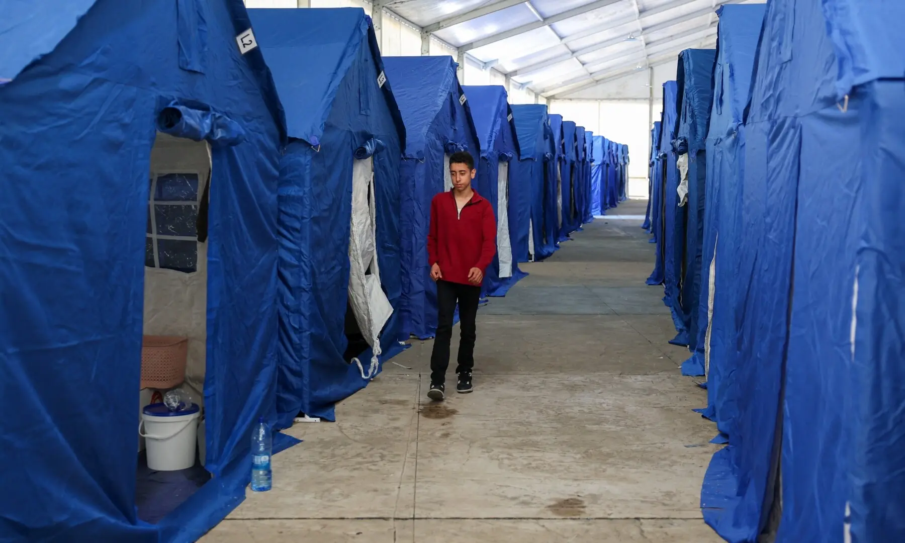 A youth walks past tents inside Camille Chamoun Sports City stadium, turned into a temporary shelter in Beirut, Lebanon on May 8, 2026. &mdash;Reuters