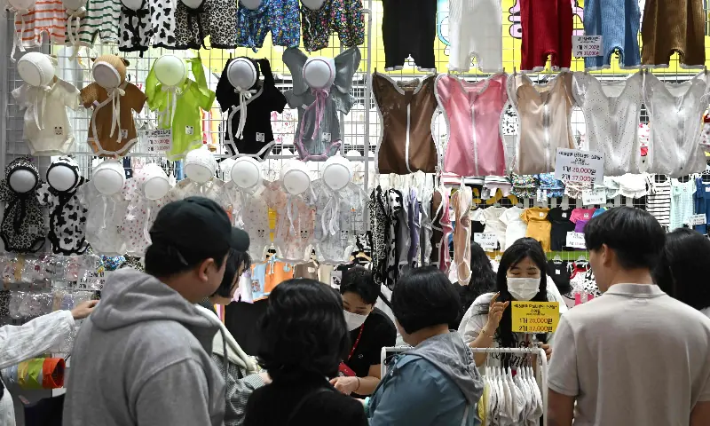 This picture taken on April 30, 2026 shows baby clothes displayed at a booth during a baby fair in Seoul. &mdash; AFP