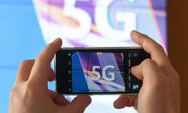 In this file photo, a man is seen capturing a photo with a mobile phone. &mdash; AFP/File