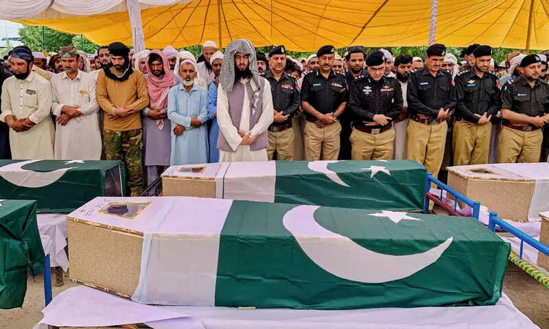 Police officials and relatives offer funeral prayers for security personnel, following a car bombing attack in the Fateh Khel area of Bannu.&mdash;AFP