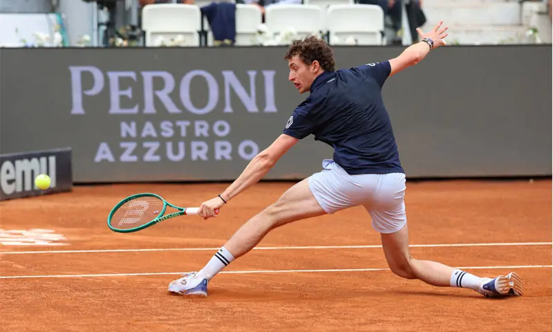 ROME: France’s Ugo Humbert plays a return against Dino Prizmic of Croatia during their Italian Open match at Foro Italico on Sunday.—Reuters ROME: France’s Ugo Humbert plays a return against Dino Prizmic of Croatia during their Italian Open match at Foro Italico on Sunday.—Reuters
