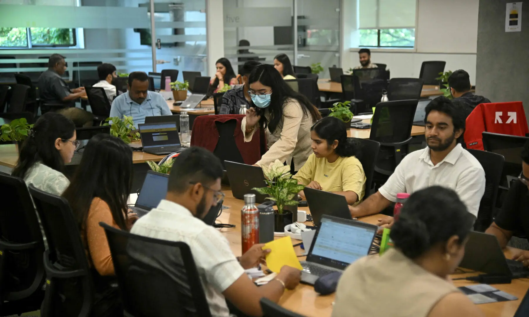 This photograph taken on April 9, 2026 shows Go Digit Insurance employees working at their office in Bengaluru. — AFP