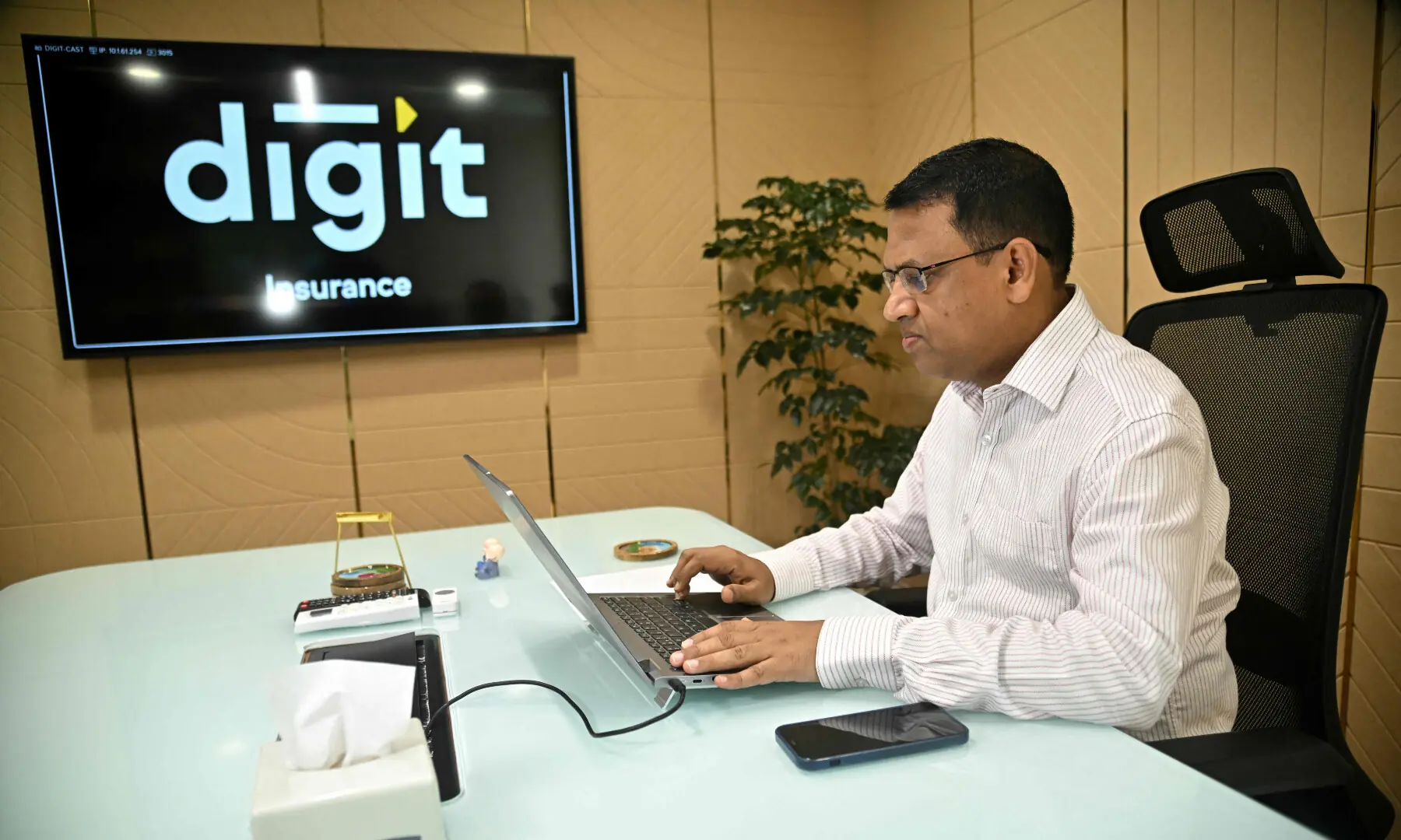 This photograph taken on April 9, 2026 shows Adarsh Agarwal, appointed actuary at Go Digit Insurance, working inside their office in Bengaluru. — AFP