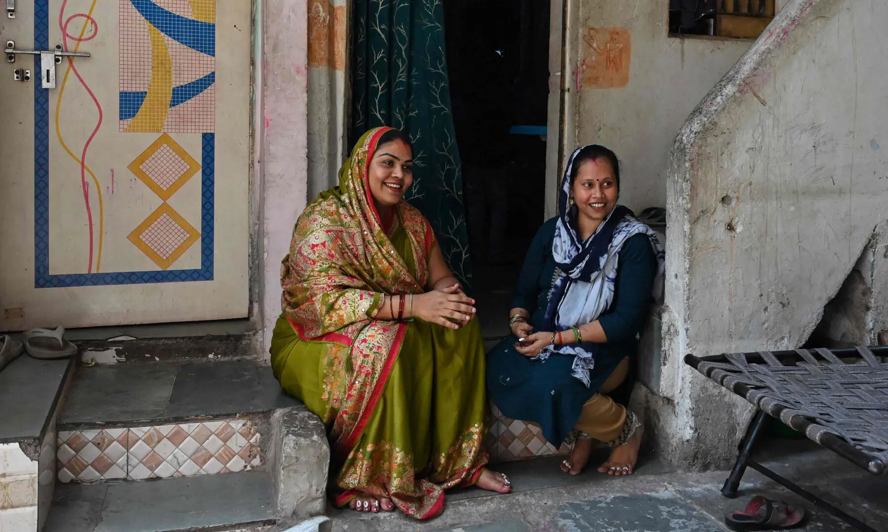 This photograph taken on April 28, 2026 shows Rakhi Gulshan Singh (R), a seamstress and policyholder of a heat insurance scheme, sitting outside her single-room rented house in Ahmedabad. — AFP This photograph taken on April 28, 2026 shows Rakhi Gulshan Singh (R), a seamstress and policyholder of a heat insurance scheme, sitting outside her single-room rented house in Ahmedabad. — AFP