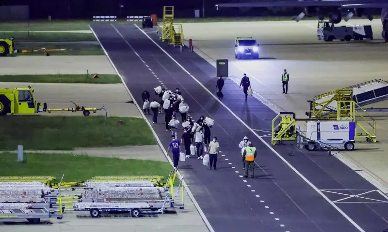 Passengers evacuated from the cruise ship MV Hondius, which was affected by a hantavirus outbreak, walk after disembarking at Eindhoven Air Base, Netherlands on May 12, 2026. &mdash;Reuters