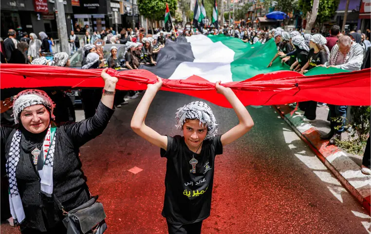 People march with a giant Palestinian flag during a demonstration in Ramallah commemorating the 78th anniversary of Nakba — the 1948 displacement of Palestinians during the creation of Israel.—AFP People march with a giant Palestinian flag during a demonstration in Ramallah commemorating the 78th anniversary of Nakba — the 1948 displacement of Palestinians during the creation of Israel.—AFP