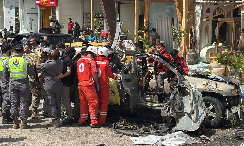 Rescuers inspect a car hit in an Israeli strike in Jiyeh area south of Beirut, Lebanon May 13. &mdash; Reuters
