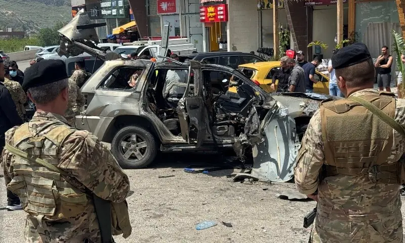 Lebanese army soldiers keep guard at the site of an Israeli strike on a car in Jiyeh area south of Beirut, Lebanon May 13. &mdash; Reuters