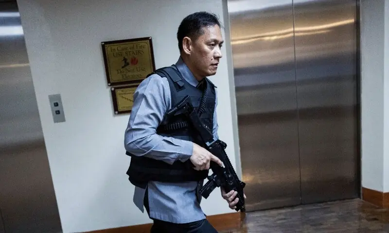 A member of the senate security walks after gunshots were heard at the Philippine Senate in Pasay City, Metro Manila on May 13, 2026. — Reuters
