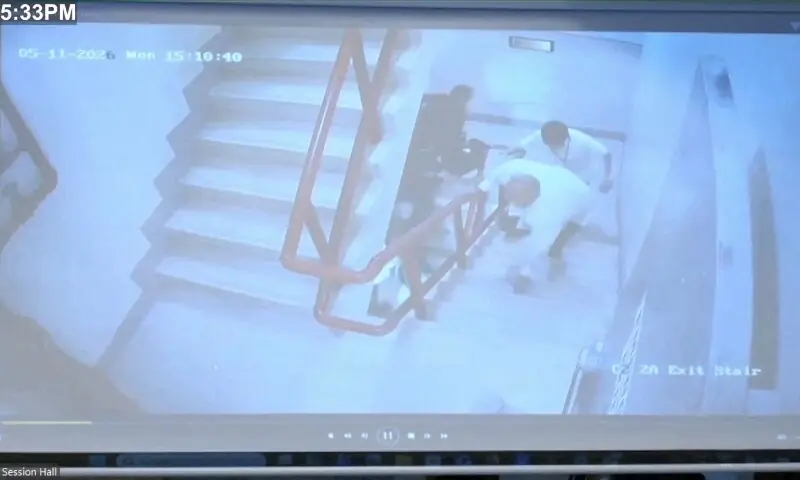 Philippine Senator Ronald dela Rosa stumbles on stairs as he runs away from Philippine law enforcement agents inside the Philippine Senate building, Manila, Philippines, May 11, 2026, in this still image taken from a video of CCTV footage playing on a screen.