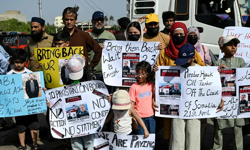 KARACHI: Families of Pakistani seamen, currently held captive by Somali pirates, stage a demonstration near the city port, urging the government to ensure their safe return.—AFP KARACHI: Families of Pakistani seamen, currently held captive by Somali pirates, stage a demonstration near the city port, urging the government to ensure their safe return.—AFP