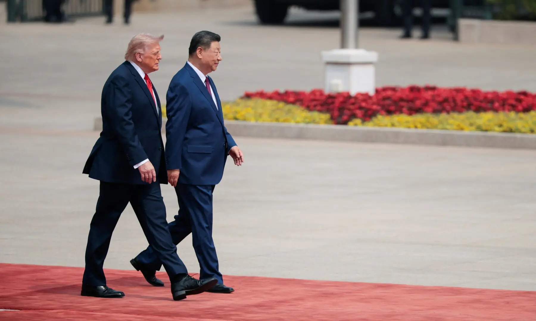 US President Donald Trump walks with Chinese President Xi Jinping upon arrival at the Great Hall of the People in Beijing, China, May 14, 2026. &mdash; Reuters