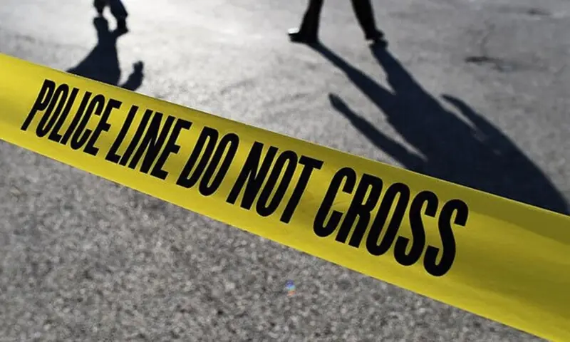This illustration shows silhouette of police officials behind crime scene tape. &mdash; AFP/File