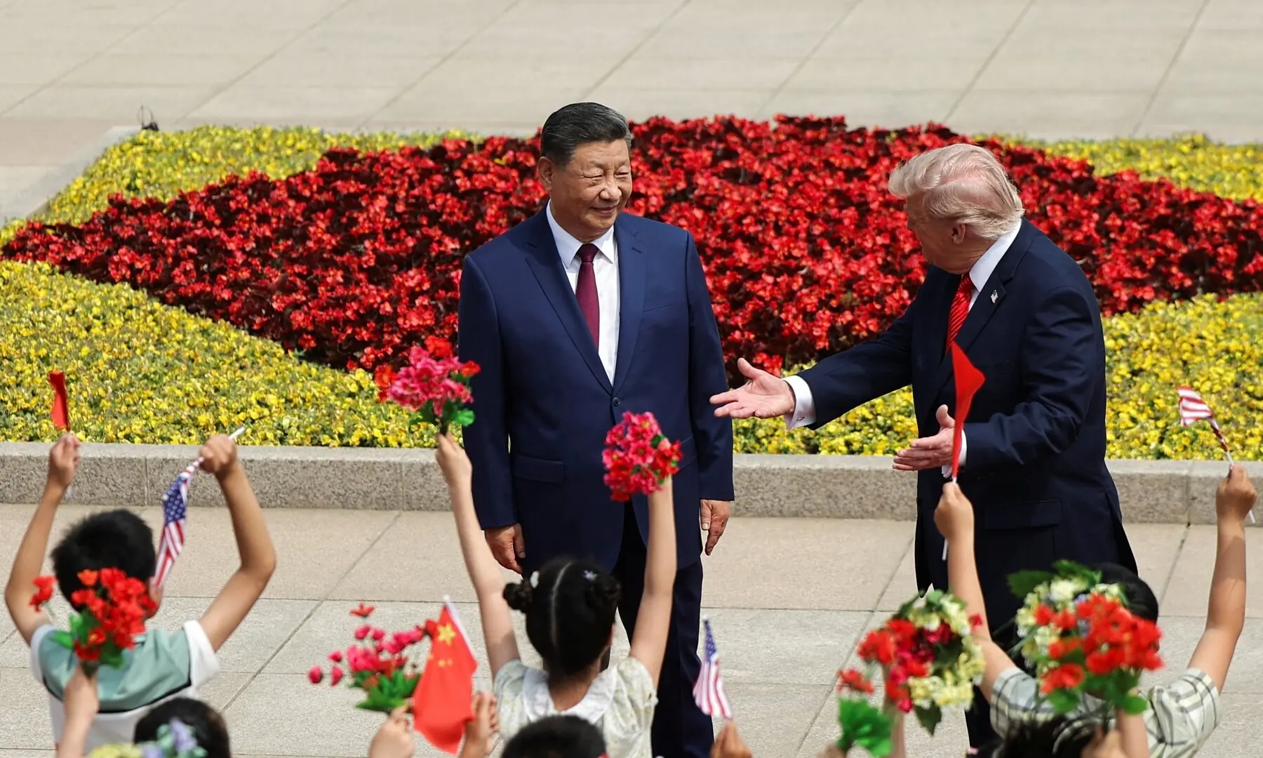 Children hold Chinese and U.S. flags, as US President Donald Trump participates in a welcome ceremony with Chinese President Xi Jinping at the Great Hall of the People in Beijing, China, May 14, 2026. &mdash;Reuters