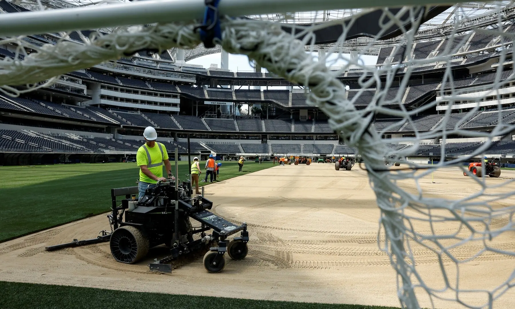 Workers install patches of grass to be used as part of the pitch at SoFi Stadium, ahead of the FIFA World Cup soccer tournament, in Inglewood, California, US, May 13, 2026. &mdash;Reuters