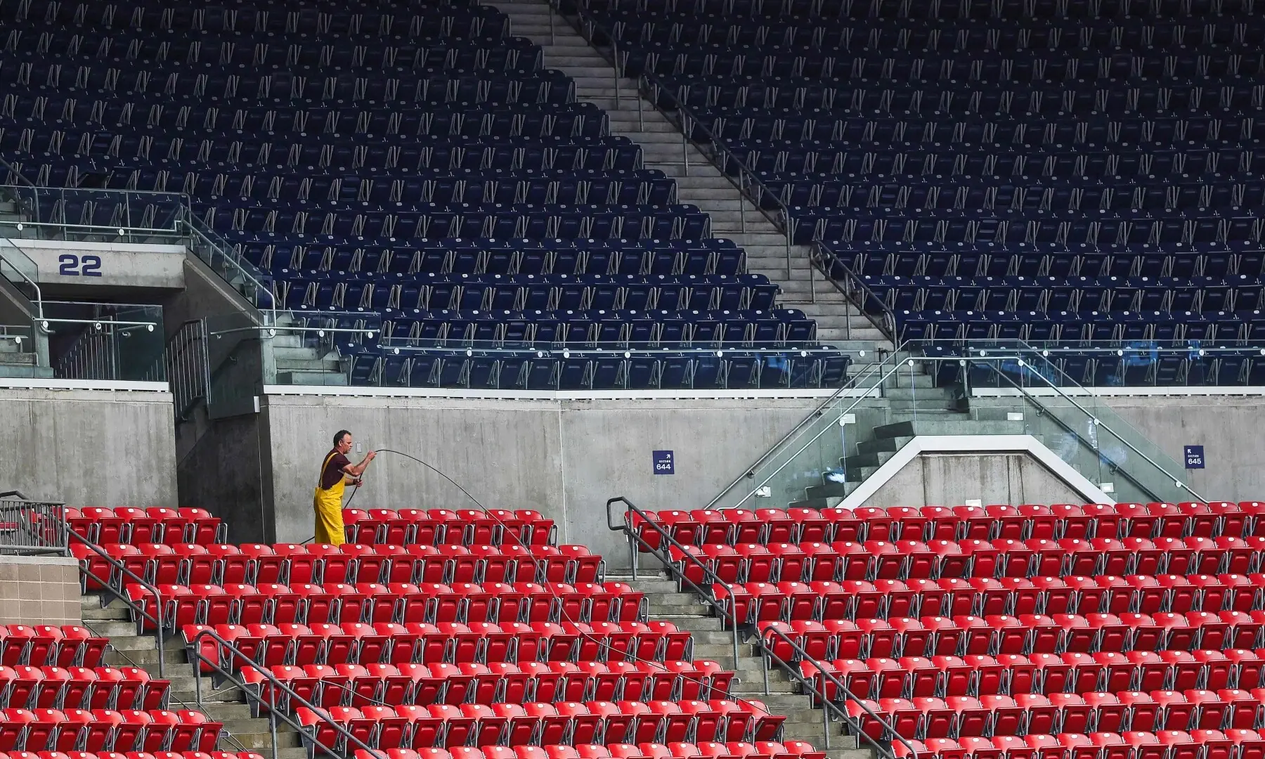 A worker cleans seats at Houston Stadium on May 13, 2026 in Houston, Texas. Houston Stadium, officially named NRG Stadium, will host seven matches during the 2026 FIFA World Cup. &mdash;AFP