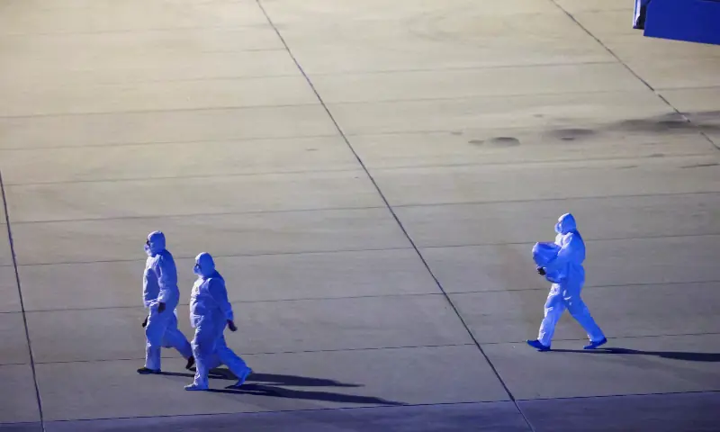 Personnel in hazmat suits walk near a plane carrying passengers evacuated from the cruise ship MV Hondius, which was affected by a hantavirus outbreak, after it landed at the Eindhoven Air Base in Eindhoven, Netherlands on May 12, 2026. — Reuters
