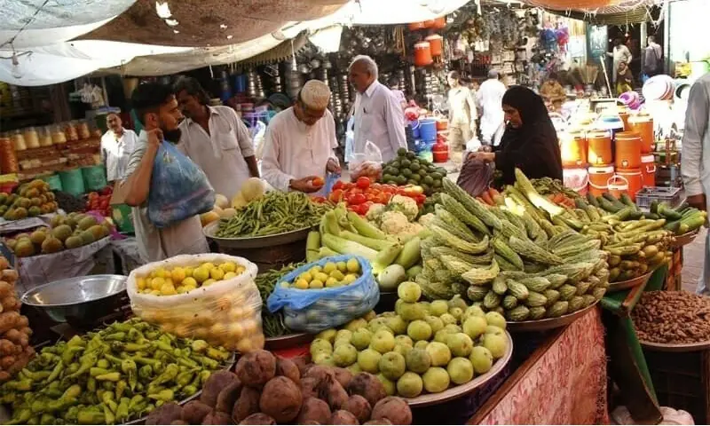 In this file photo, people buy vegetables from Karachi's Empress Market. &mdash; Photo by Shahab Nafees/File