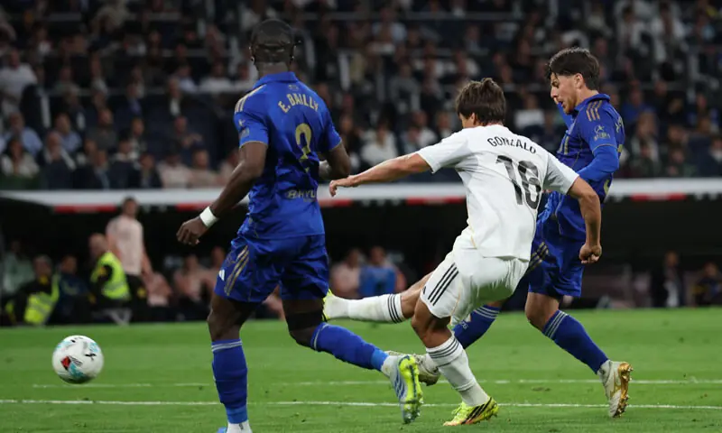 MADRID: Gonzalo Garcia (C) of Real Madrid shoots to score against Real Oviedo during their La Liga match at Santiago Bernabeu.&mdash;Reuters