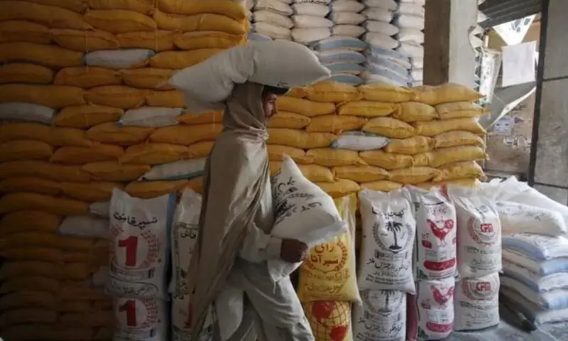A labourer carries a bag of flour from a warehouse.—Reuters/File A labourer carries a bag of flour from a warehouse.—Reuters/File