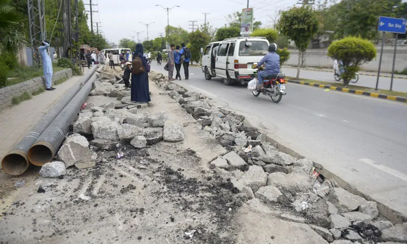 Two years after its construction, Rashid Minhas Road has been dug up once again for development work. &mdash; Photo by Mohammad Asim