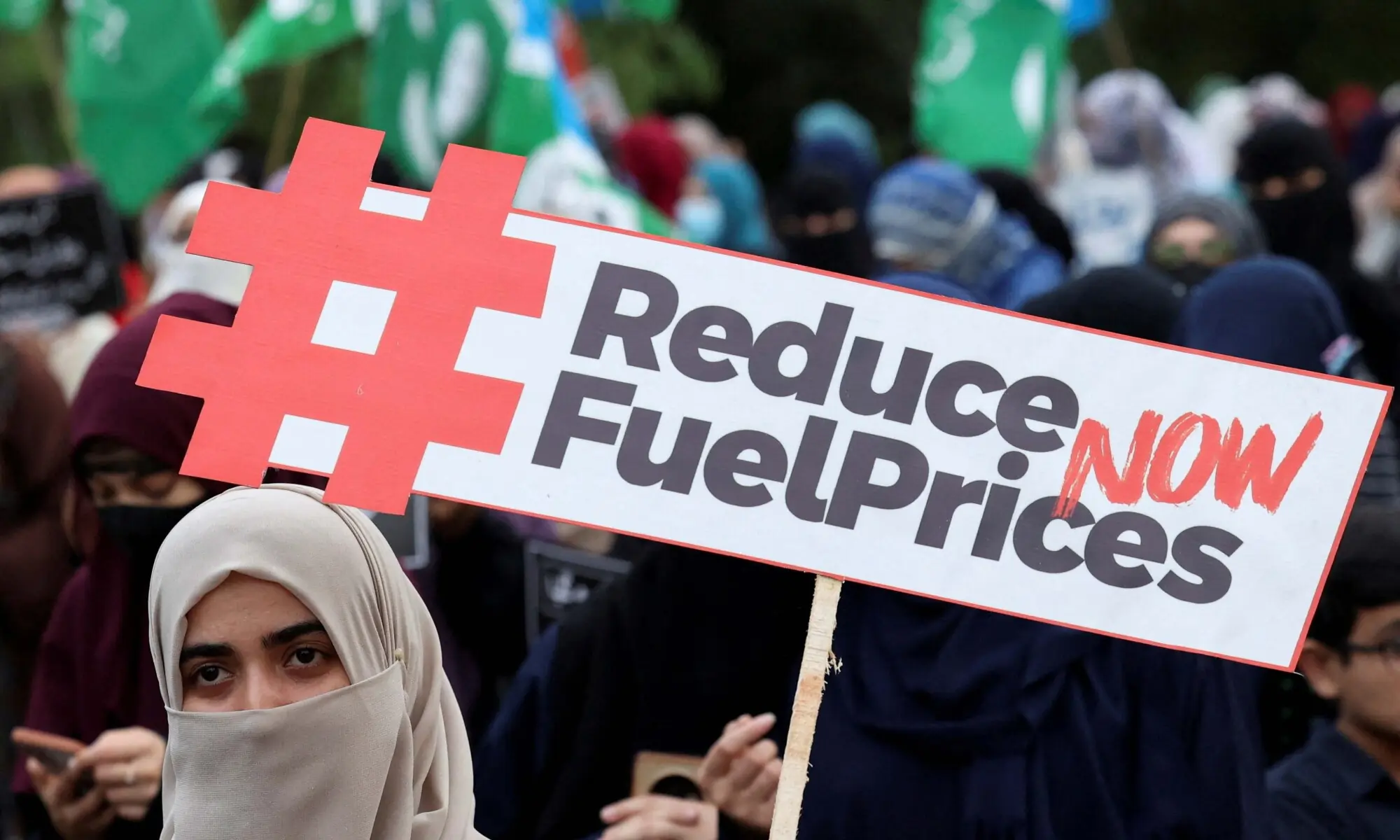 A woman holds a placard during a protest, calling the government to reduce the fuel prices, amid the U.S.-Israeli conflict with Iran, during a protest rally organized by the religious and political party Jamaat-e-Islami (JI) in Islamabad, Pakistan May 15, 2026. &mdash; Reuters