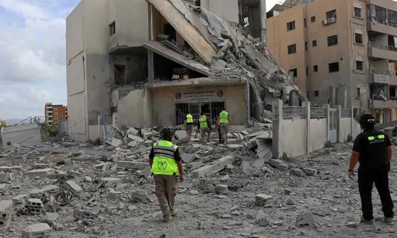 First responders inspect the destruction at the site of an Israeli airstrike that targeted the headquarters of a local NGO, in the southern coastal city of Tyre on May 15, 2026. &mdash;AFP