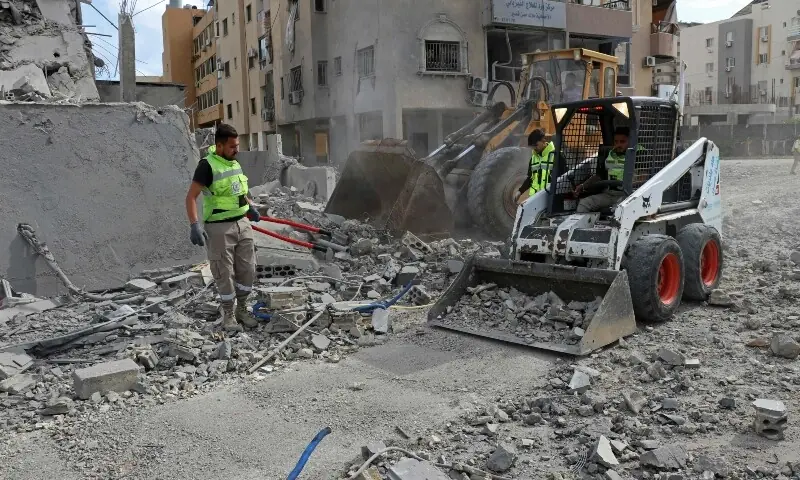 First responders clear the debris near the site of an Israeli airstrike that targeted the headquarters of a local NGO, in the southern coastal city of Tyre on May 15, 2026. &mdash;AFP