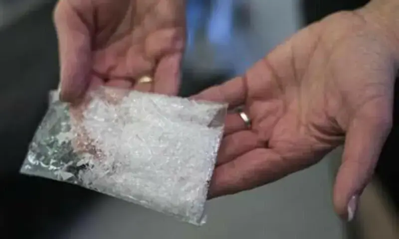 In this file photo, a woman holds a bag of crystal meth. — Reuters In this file photo, a woman holds a bag of crystal meth. — Reuters