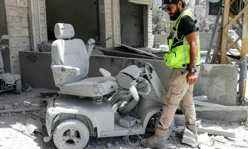 A first responder walks past a broken disabled-person&rsquo;s mobility cart while inspecting damage following Israeli bombardment on the village of Deir Qanoun al-Nahr in southern Lebanon on May 17, 2026. &mdash; AFP