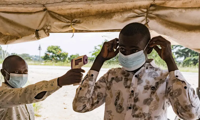 A border health officer at the Busunga crossing between Uganda and the Democratic Republic of Congo checks a traveler’s temperature using a contactless infrared thermometer in Bundibugyo, on May 18, 2026. — AFP A border health officer at the Busunga crossing between Uganda and the Democratic Republic of Congo checks a traveler’s temperature using a contactless infrared thermometer in Bundibugyo, on May 18, 2026. — AFP