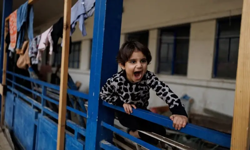 A child reacts while playing in the yard of a school used as a temporary shelter for displaced people, in Beirut, Lebanon, April 18. &mdash;Reuters