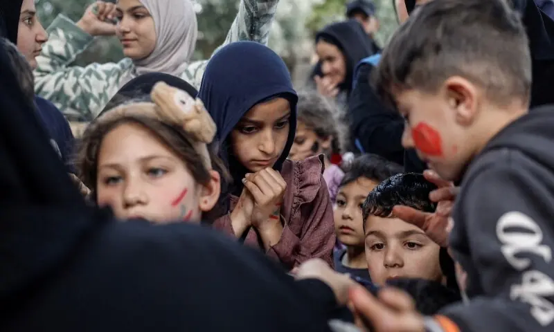 Displaced children queue to get toys, in a shelter in Tyre, south Lebanon, April 18. &mdash;Reuters