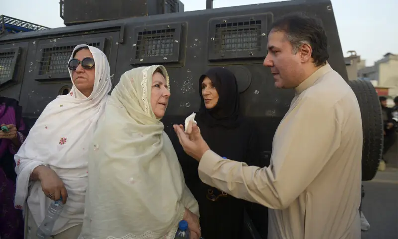 MEMBERS of Imran Khan’s family confer after being stopped from proceeding to Islamabad.—Mohammad Asim/White Star MEMBERS of Imran Khan’s family confer after being stopped from proceeding to Islamabad.—Mohammad Asim/White Star
