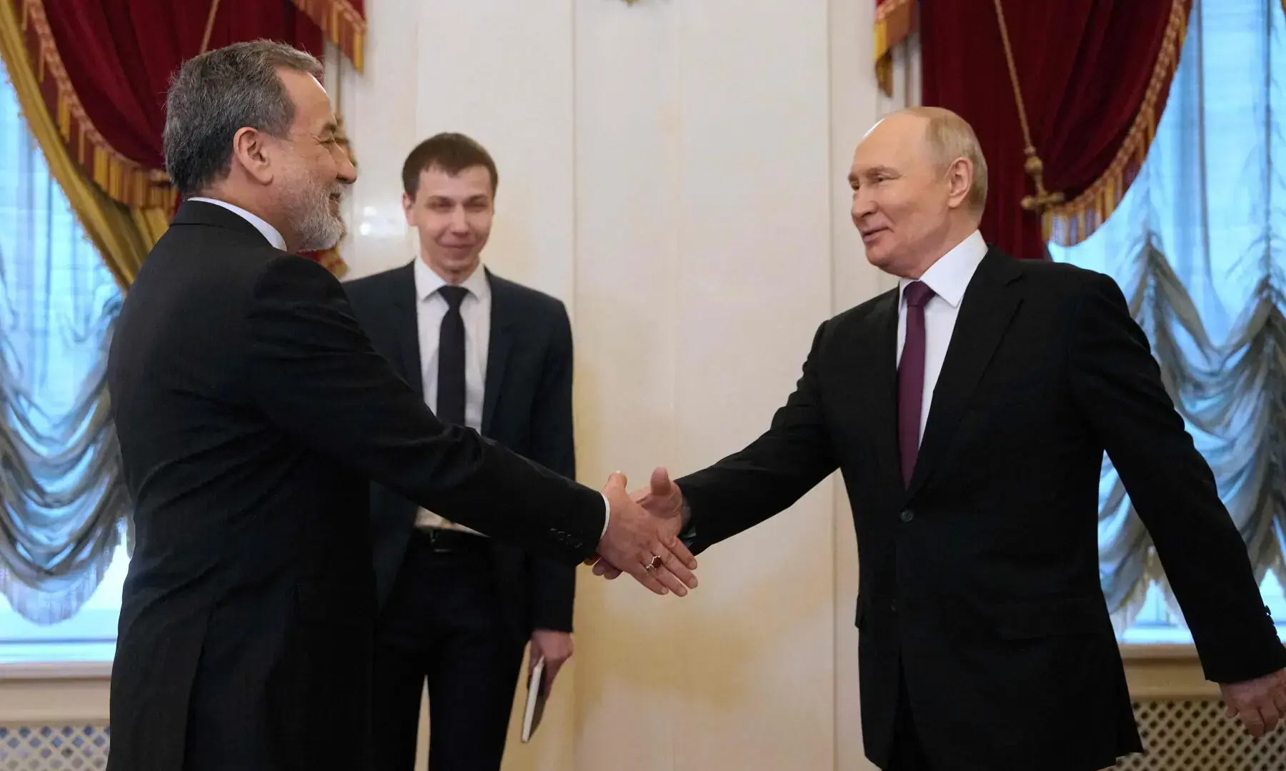 Russian President Vladimir Putin shakes hands with Iranian Foreign Minister Abbas Araghchi during their meeting at the Boris Yeltsin Presidential Library in Saint Petersburg on April 27, 2026. — AFP/File