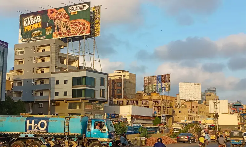 Advertising hoardings have been precariously installed on buildings along Defence Road near Akhtar Colony Chowrangi. Many such billboards have collapsed in the past during strong winds. &mdash;Shakil Adil / White Star