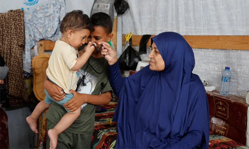 NAJIA Abu Lehia, with her grandchildren at a camp for displaced Palestinians, speaks about her wish to perform Haj.&mdash;Reuters