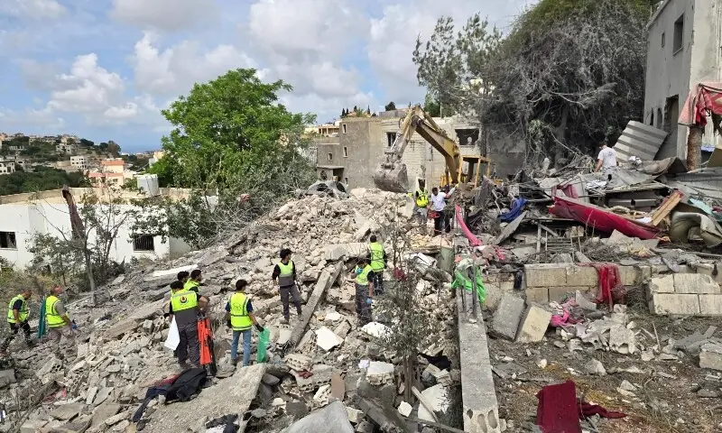 Lebanese civil defence workers search through the rubble in the southern Lebanese village of Deir Qanun al-Nahr on May 20, 2026. &mdash;AFP