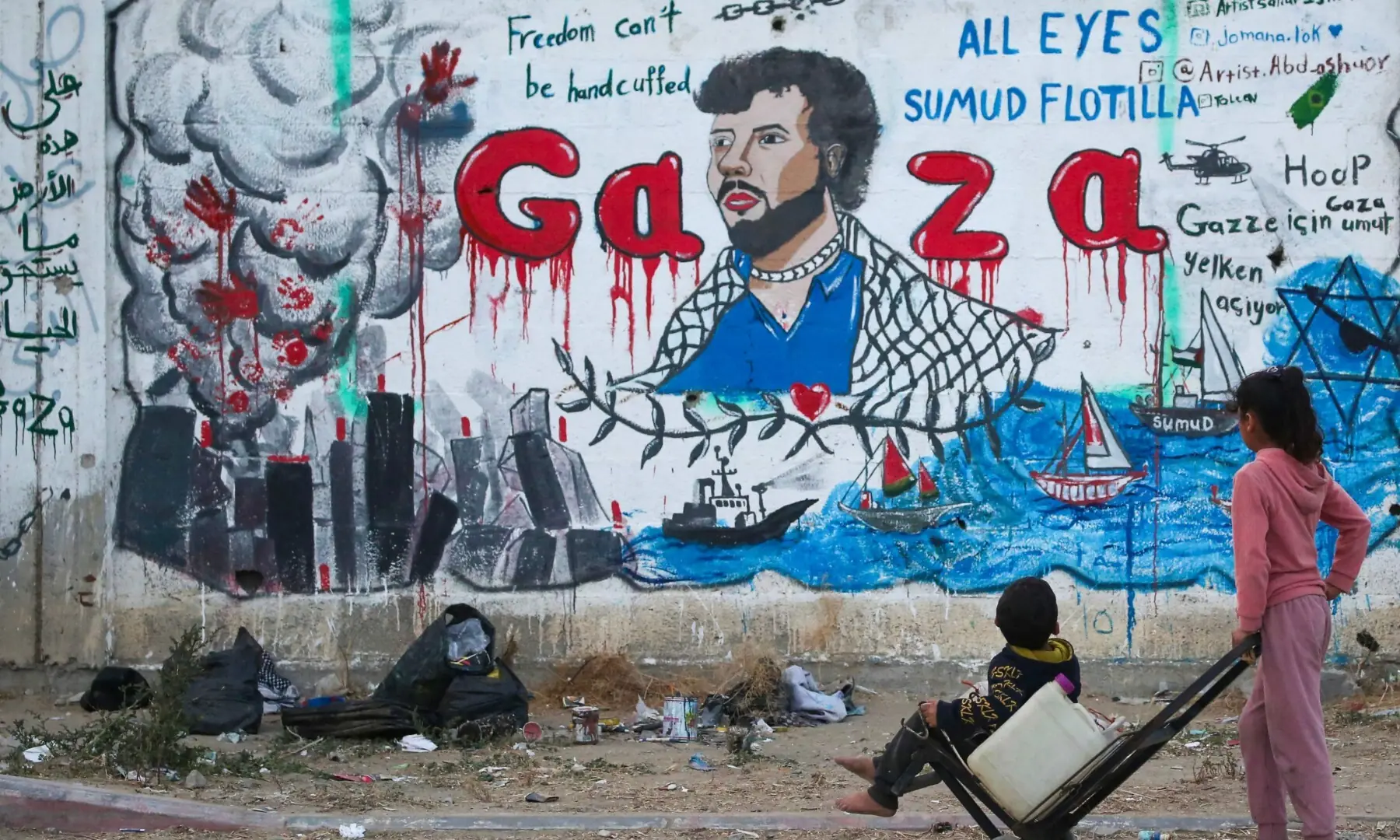 Palestinian children look at a mural depicting Israel's interception of ships participating in the Global Sumud Flotilla, a civilian-led humanitarian aid mission to Gaza by sea, in Nuseirat in the central Gaza Strip on May 19, 2026. — AFP Palestinian children look at a mural depicting Israel's interception of ships participating in the Global Sumud Flotilla, a civilian-led humanitarian aid mission to Gaza by sea, in Nuseirat in the central Gaza Strip on May 19, 2026. — AFP
