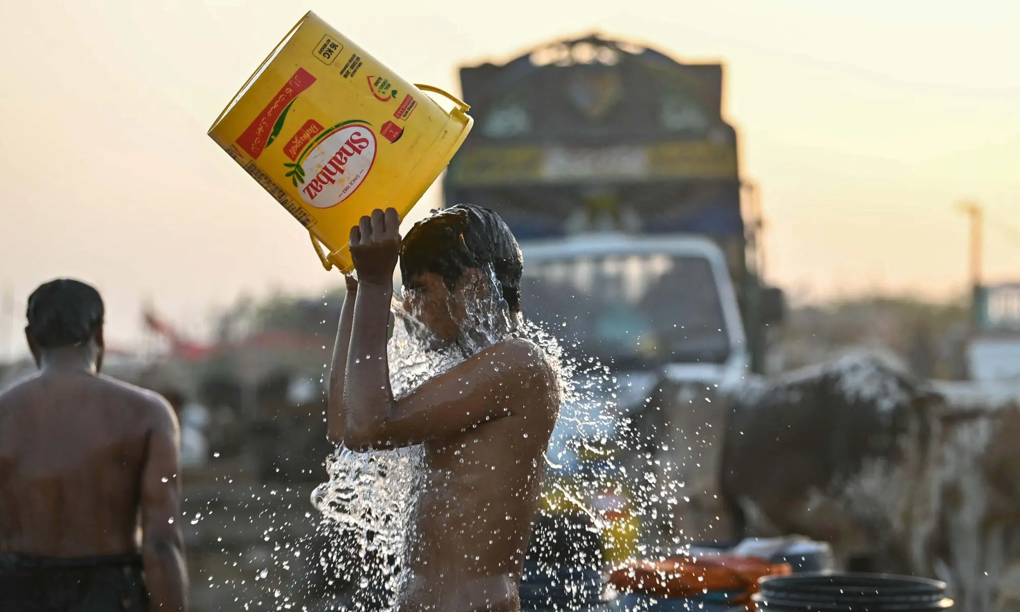 A vendor cools off during a hot summer day at a livestock market on the outskirts of Karachi on May 19, 2026 ahead of Eidul Azha. — AFP A vendor cools off during a hot summer day at a livestock market on the outskirts of Karachi on May 19, 2026 ahead of Eidul Azha. — AFP