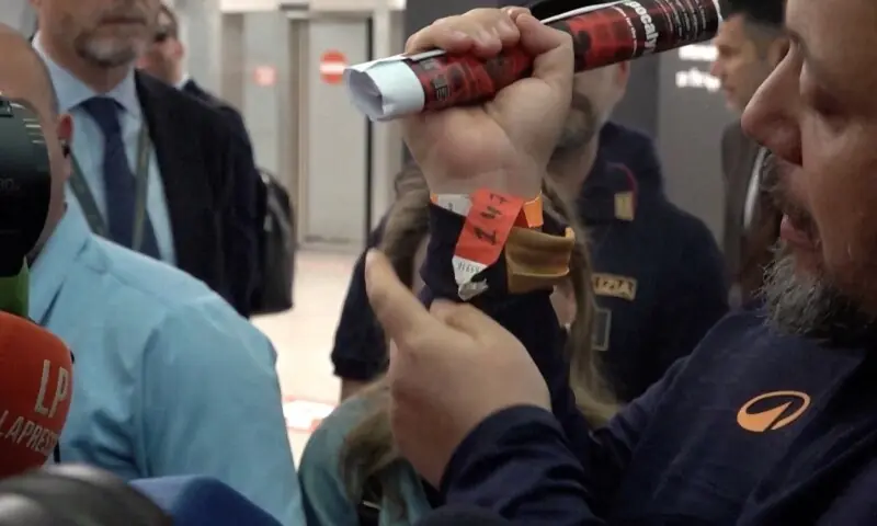 Italian lawmaker Dario Carotenuto shows a tag on his wrist to the media as he arrives at Fiumicino airport after a gaza-bound aid flotilla they were aboard was intercepted by israeli forces in international waters, in Fiumicino, Italy May 21, 2026, in this screengrab taken from a video. &mdash; Reuters