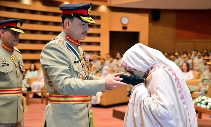 CHIEF of Defence Forces Field Marshal Asim Munir hands an award to the family member of a martyr.—PPI CHIEF of Defence Forces Field Marshal Asim Munir hands an award to the family member of a martyr.—PPI
