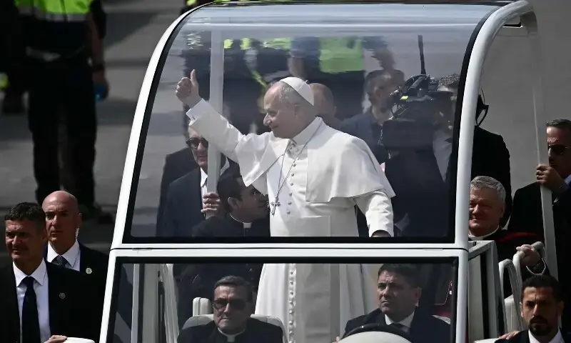 Pope Leo XIV greets the crowd from the popemobile at Piazza Nicola Calipari during a pastoral visit to the community of the 'Land of Fires' on May 23, 2026. &mdash; AFP